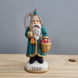 Vintage 80s 1850 Ornament Featuring Santa in a Green Jacket With Toy Bag